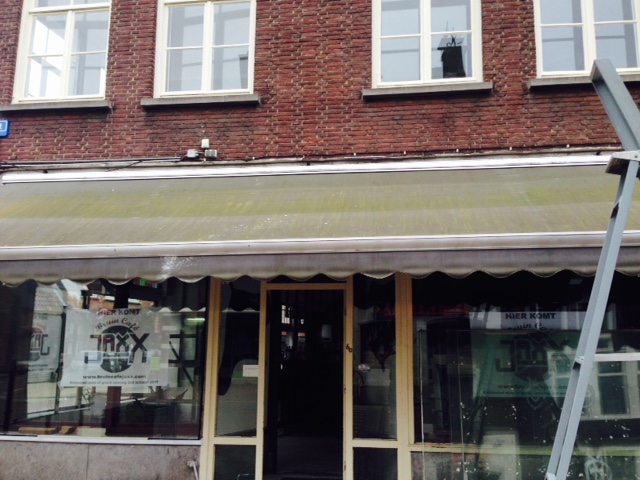 Uitvalscherm bij een café in Roosendaal voordat deze gereinigd is